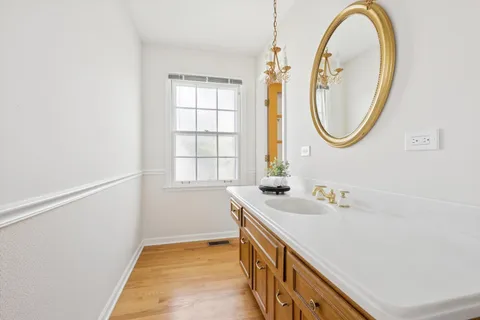 a bathroom with a tub sink and mirror
