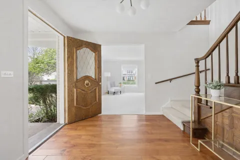 a view of entryway with wooden floor and door