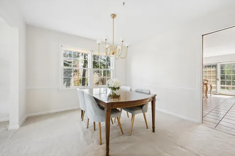 a view of a room with a table and chairs