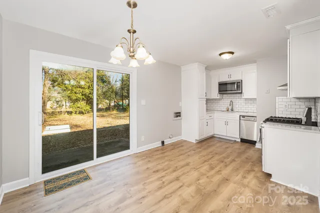 a view of a kitchen with microwave and stove