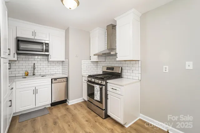 a kitchen with stainless steel appliances granite countertop a stove and a sink