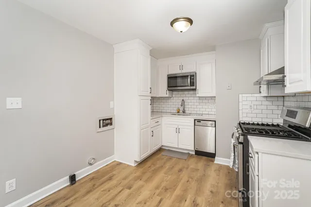 a kitchen with a stove a sink and a microwave