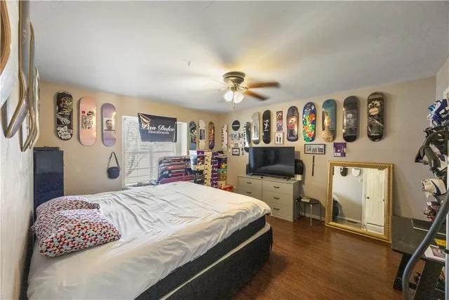 a bedroom with a bed and wooden floor