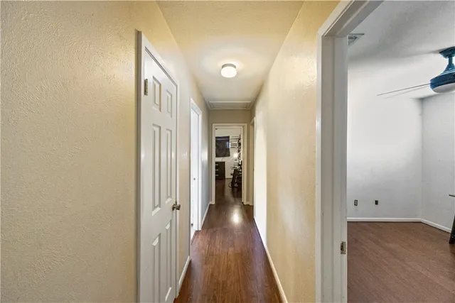 a view of hallway with wooden floor
