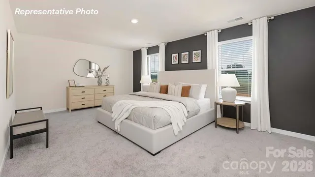 a spacious bedroom with a bed and a window