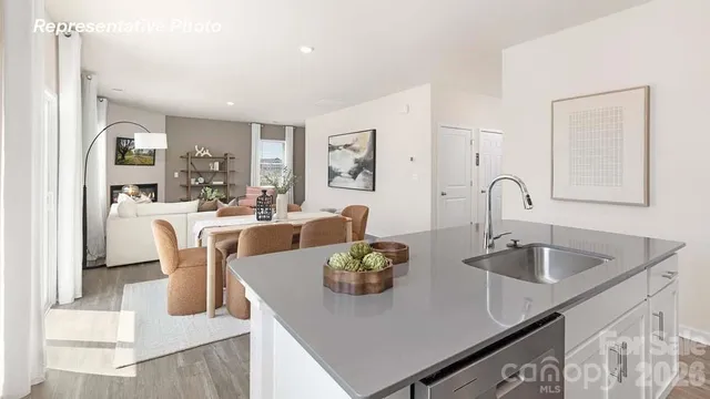 a dining room with chairs and view of kitchen
