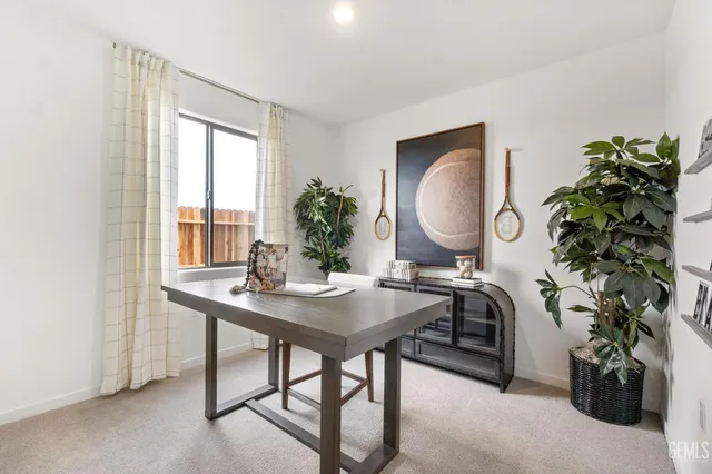 a view of a workspace room with furniture and a potted plant