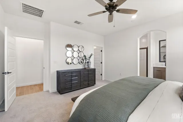 a bedroom with a bed dresser and a window