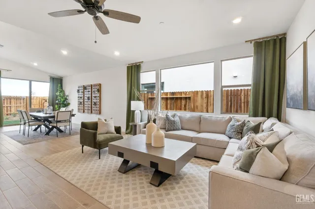 a living room with furniture and floor to ceiling windows