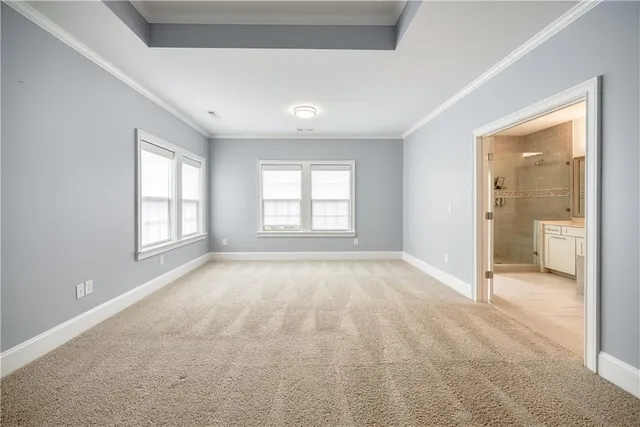 an empty room with a bathroom and a sink