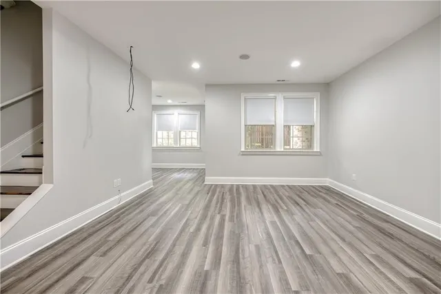 a view of empty room with wooden floor