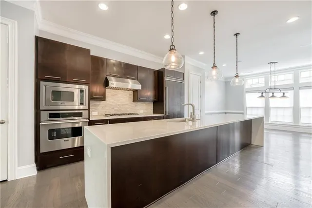 a large kitchen with granite countertop a stove and a sink