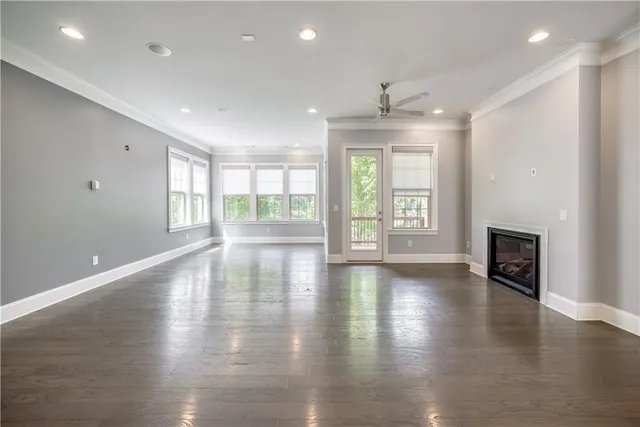 an empty room with wooden floor and a fireplace