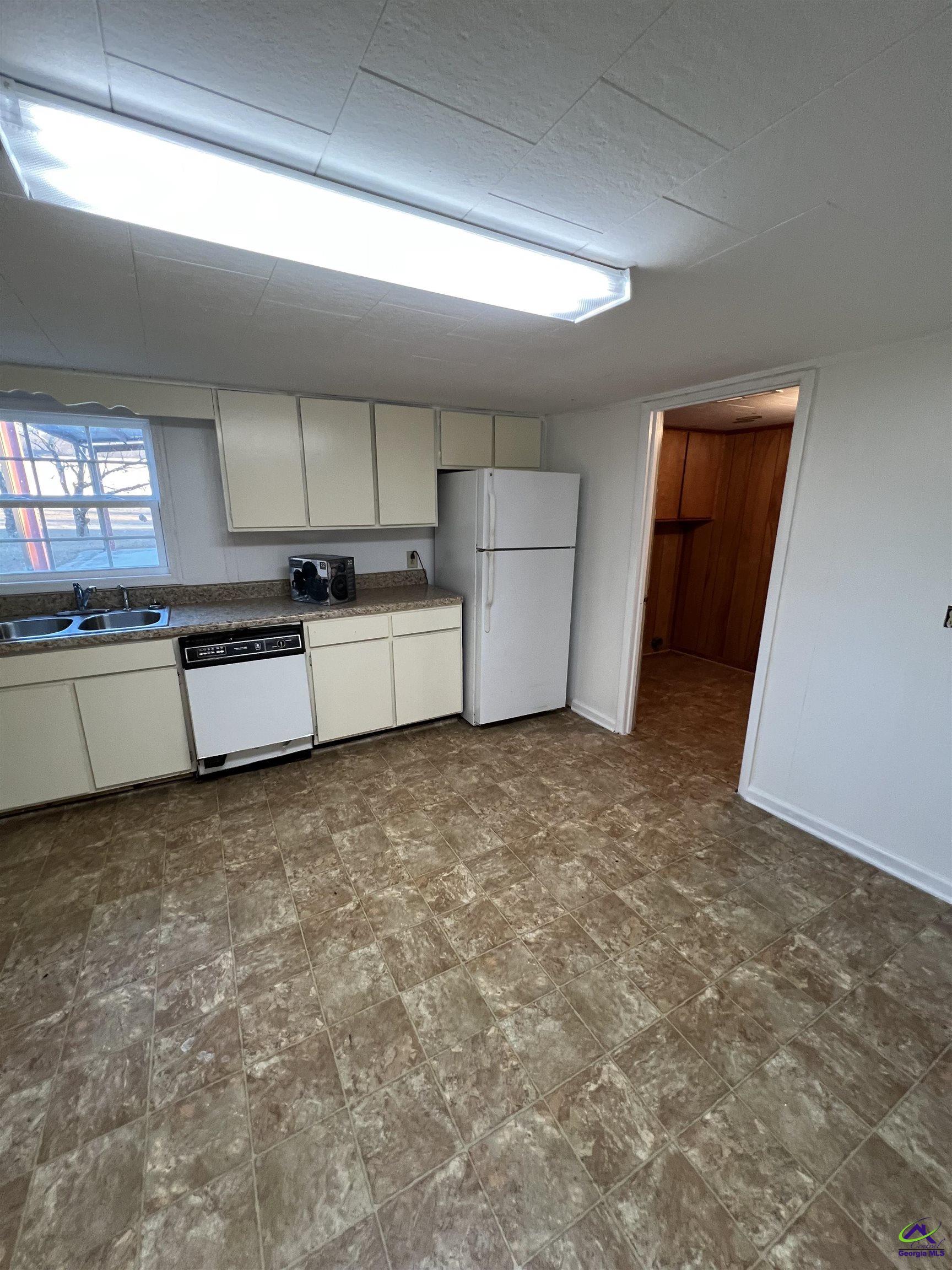 3281 State Rte 126 Dublin, GA 31021 - Photo 18 of 22 a view of a kitchen with a sink cabinets and a window