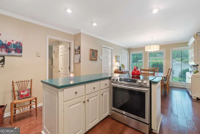 a kitchen with granite countertop a stove and a sink