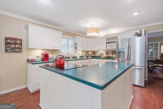 a kitchen with a stove a refrigerator and a sink