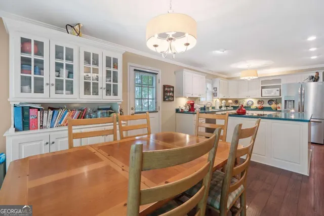 a dining room with furniture and a kitchen view