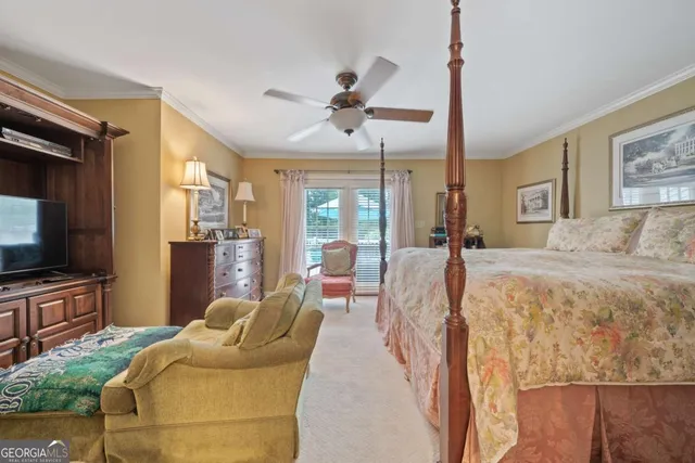 a bedroom with a bed couch and a flat screen tv