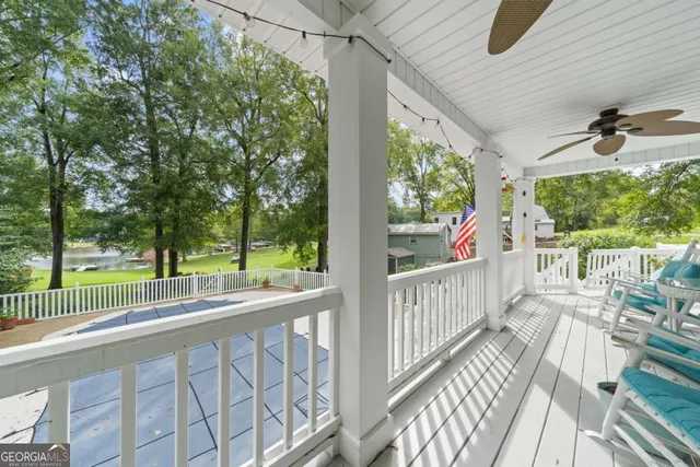 a view of a porch with wooden floor and furniture