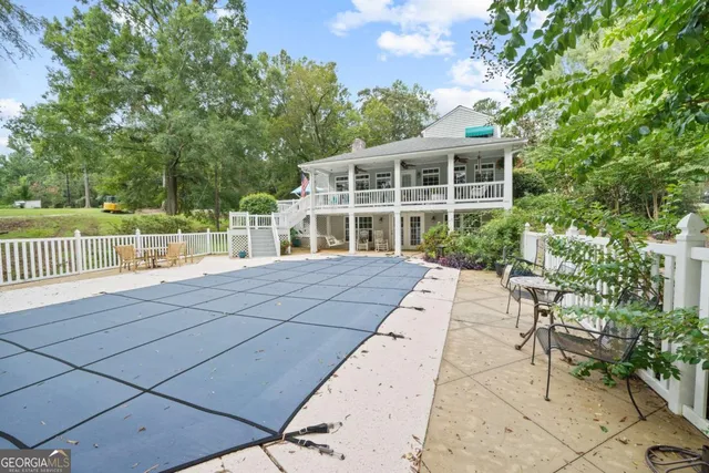 a view of a house with backyard and sitting area
