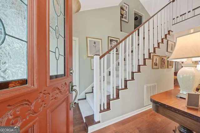 a view of an entryway with wooden floor and stairs