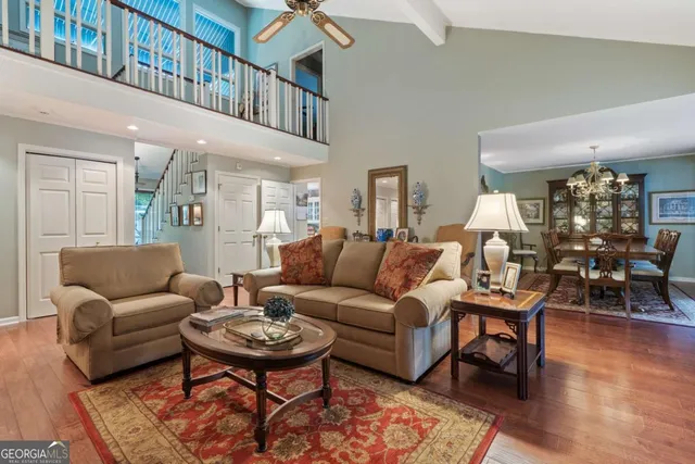 a living room with furniture a rug and a table