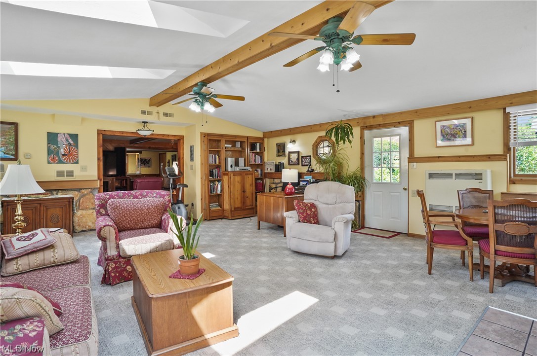 4205 Ellsworth Road Stow, OH 44224 - Photo 20 of 35 Living room with vaulted ceiling with skylight, light carpet, and ceiling fan