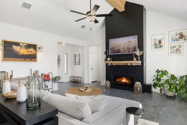 a living room with furniture and a fireplace