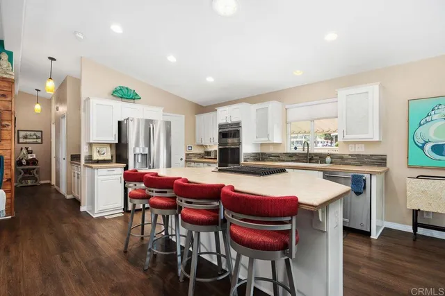 a kitchen with stainless steel appliances a stove a microwave and a refrigerator