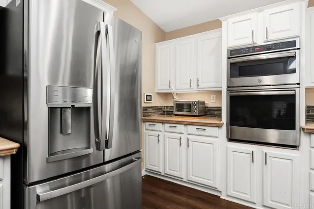 a kitchen with stainless steel appliances a sink and a stove
