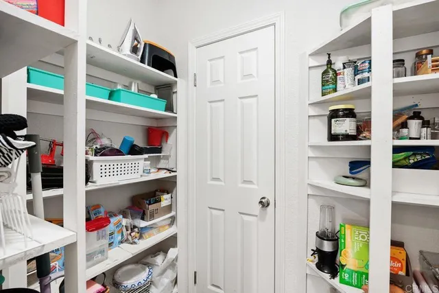 a kitchen with stainless steel appliances kitchen island granite countertop a stove a sink a dining table and chairs with wooden floor