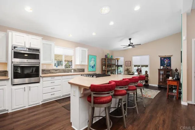 a dining room with furniture and wooden floor