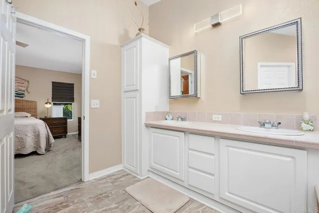 a bathroom with a double vanity sink mirror and double