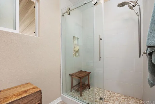 a bathroom with a granite countertop toilet sink and mirror
