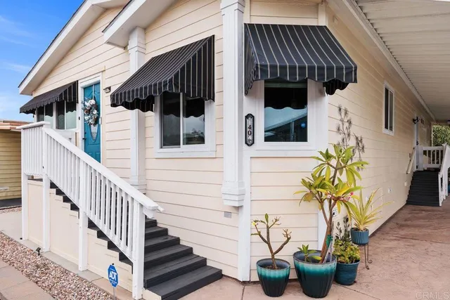 a view of front door of house with potted plant