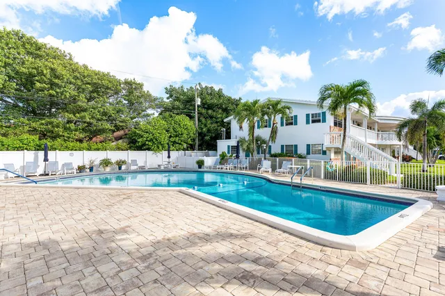 a view of swimming pool with outdoor seating and plants