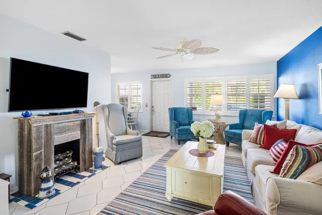 a living room with fireplace furniture and a flat screen tv