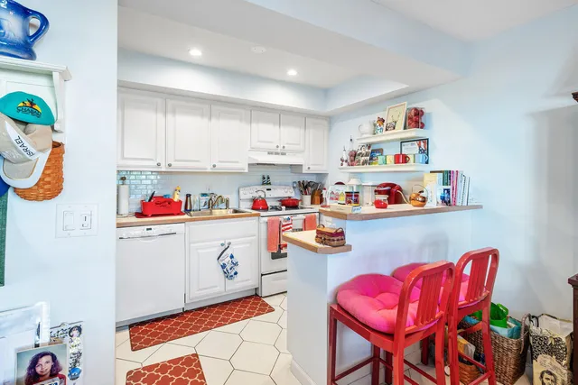 a room with furniture and white appliances