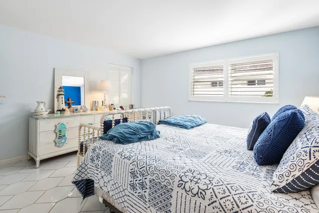 a bedroom with a bed a couch and dresser