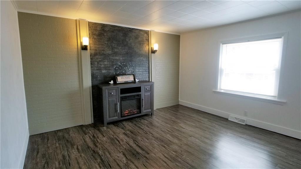 428 East Washington Street Rochester, PA 15074 - Photo 7 of 25 a view of an empty room with wooden floor and a window