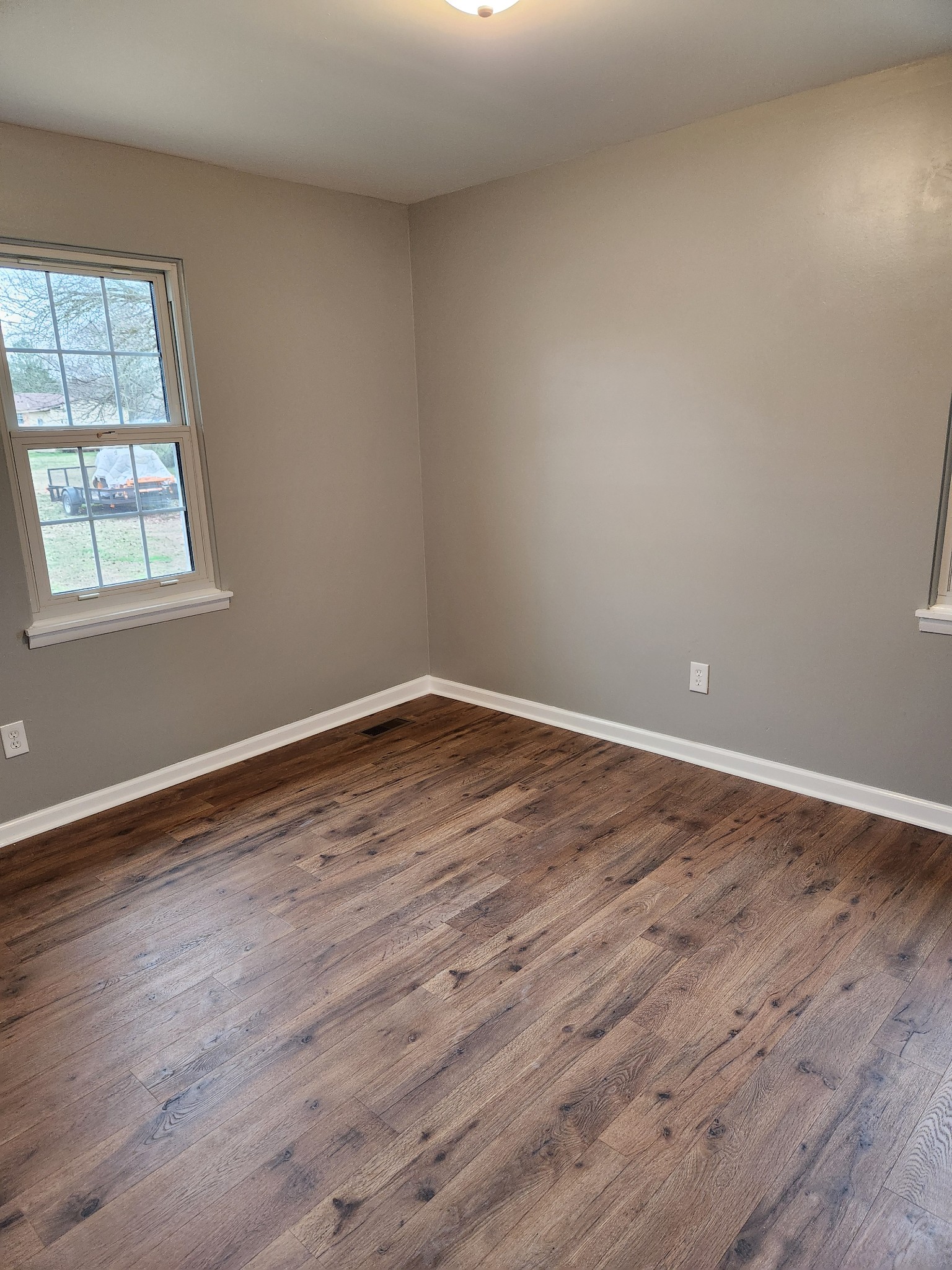 1715 Vales Mill Road Pulaski, TN 38478 - Photo 20 of 28 a view of an empty room with wooden floor and a window