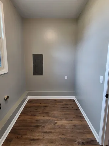 a view of a room with wooden floor and window