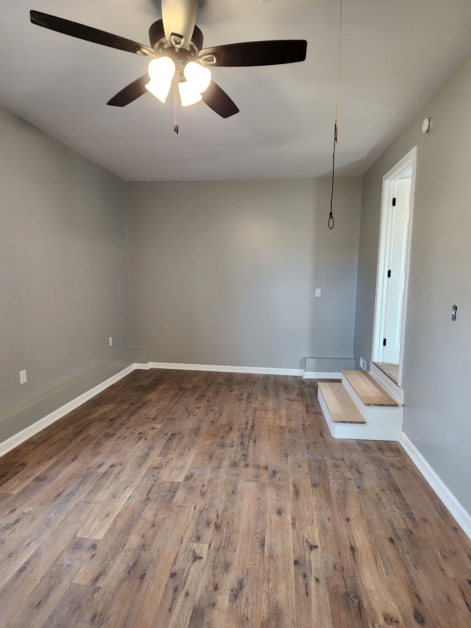 1715 Vales Mill Road Pulaski, TN 38478 - Photo 27 of 28 an empty room with wooden floor and a ceiling fan