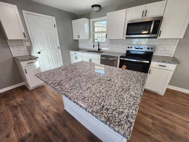 a kitchen with wooden floors and a appliances