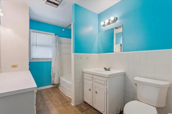 a bathroom with a sink a toilet and mirror