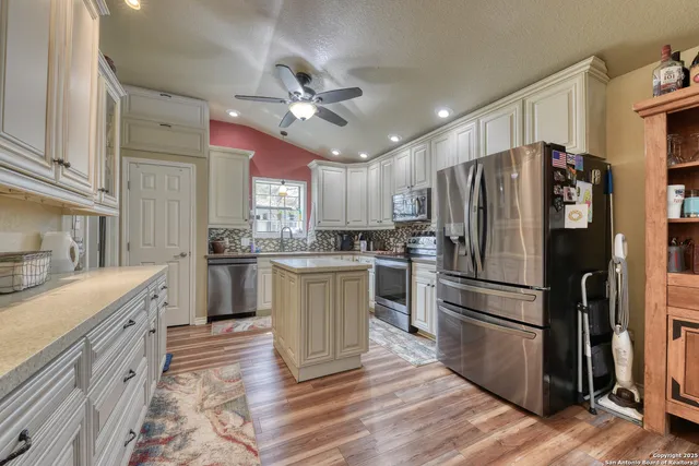 a kitchen with a refrigerator a sink and dishwasher