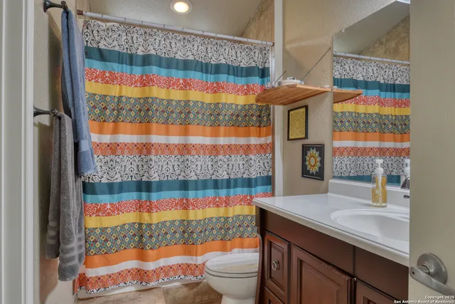 a bathroom with a sink toilet and shower