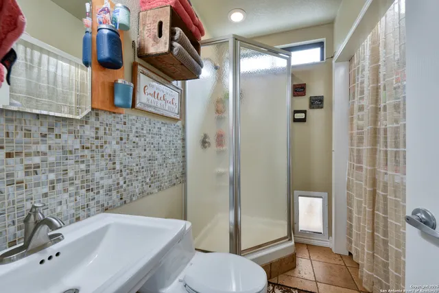 a bathroom with a sink toilet and shower