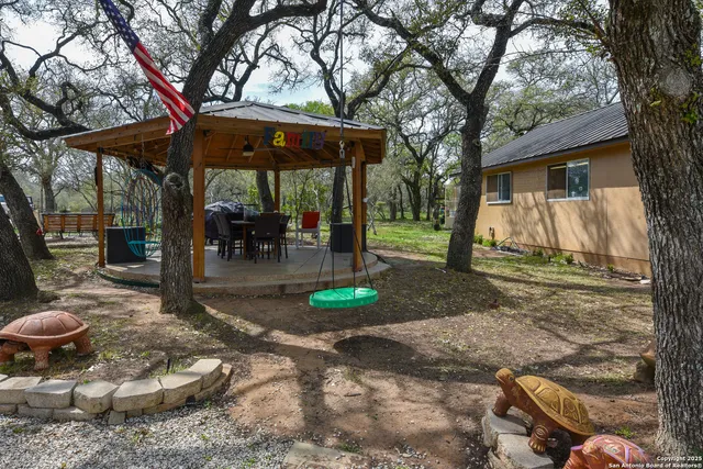 a backyard of a house with yard and outdoor seating