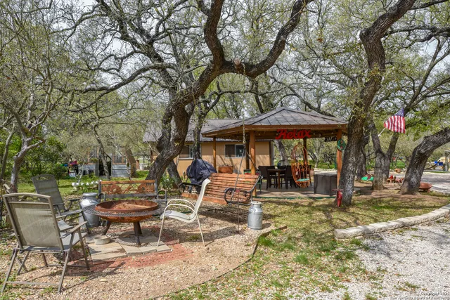 a view of a patio with table and chairs under an umbrella